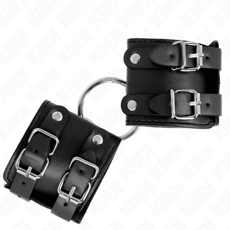 KINK - SUJECIONES DE MUÑECA FIJAS CON ANILLA Y Tachuelas AJUSTABLES NEGRAS 17-22 CM X 6.5 CM